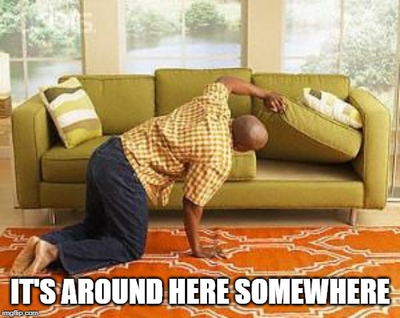 Man looking under sofa cushions and finding nothing.